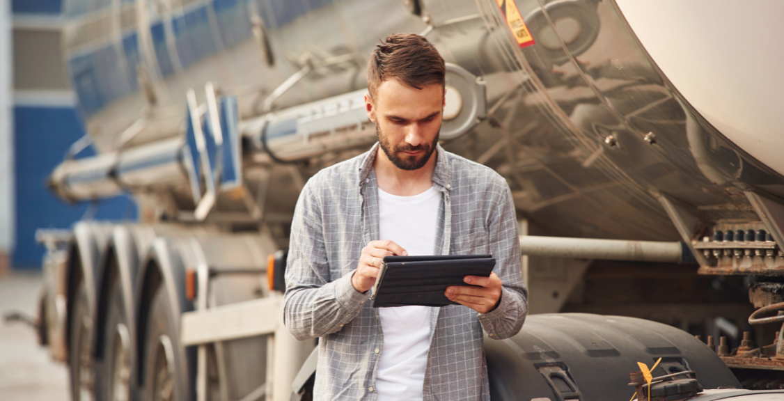 a man checking eld of a truck before going on the road