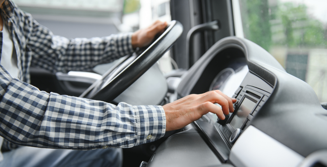 a man checking the road map on digital monitor of the truck