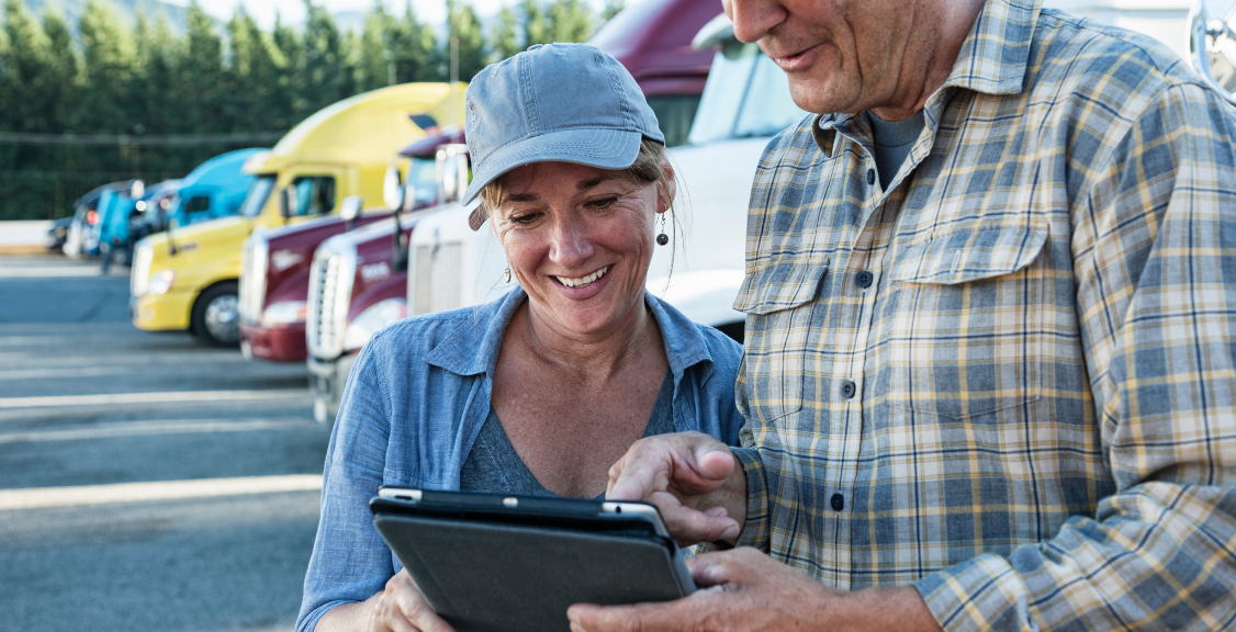 man and woman checking fleet management software