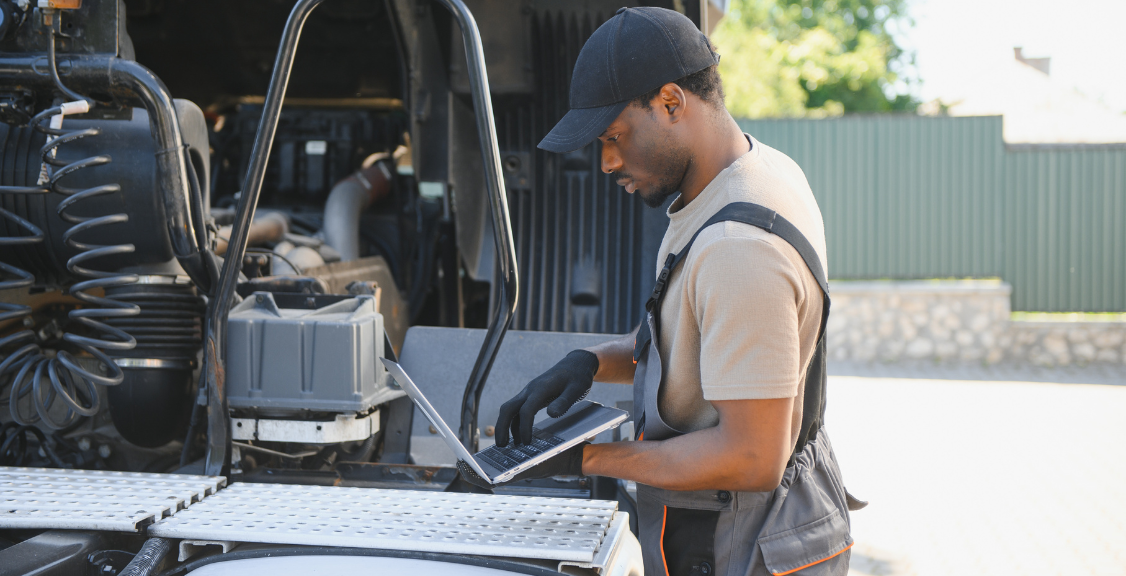 driver checking the condition of the truck using laptop