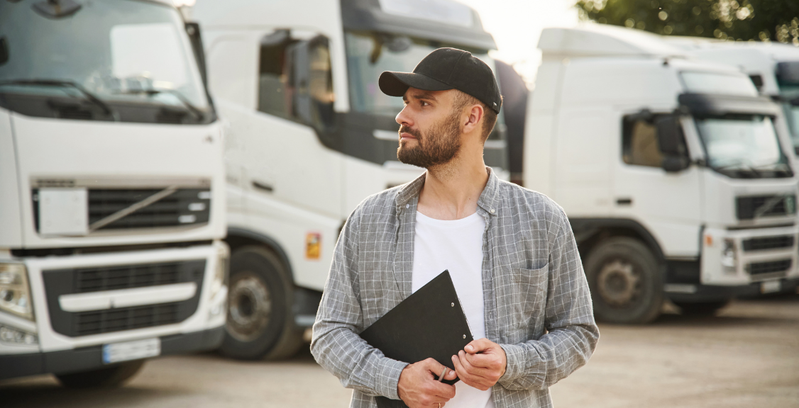 a man looking far away in front of fleet trucks