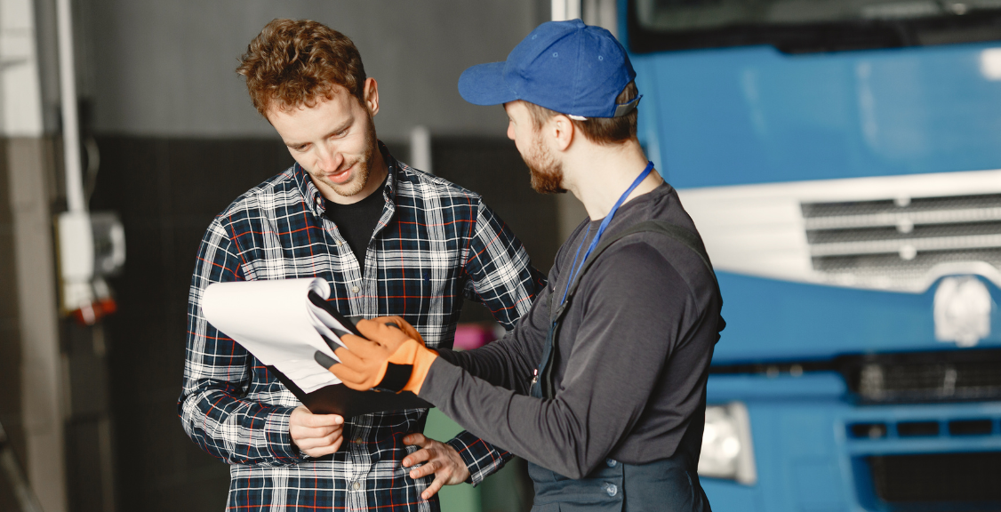 two man checking the compliance checklist of the trucks