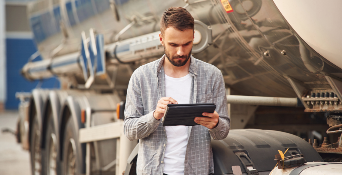 a man checking on a telematics tab for truck management