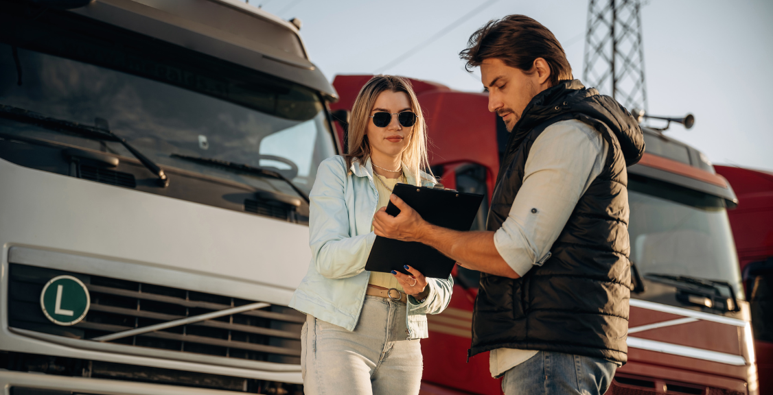 truck driver holding documents and woman signing the documents